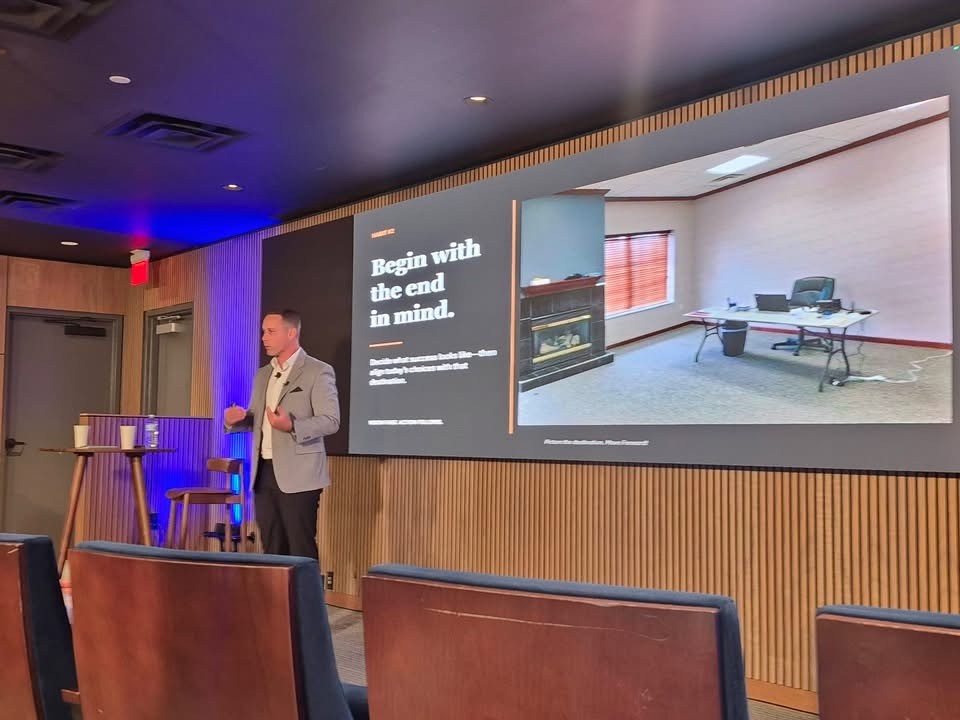 Tony presenting to an audience at a conference